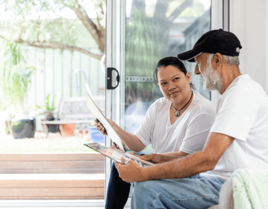 Woman and Elderly Man Examining Some Documents