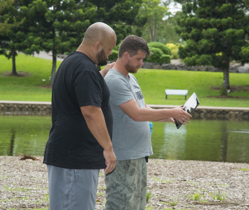 Mental Health Support Worker and NDIS Participant Looking at an iPad