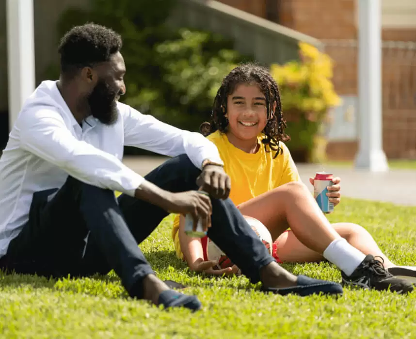 Kid and NDIS Staff Rests after a Game of Football