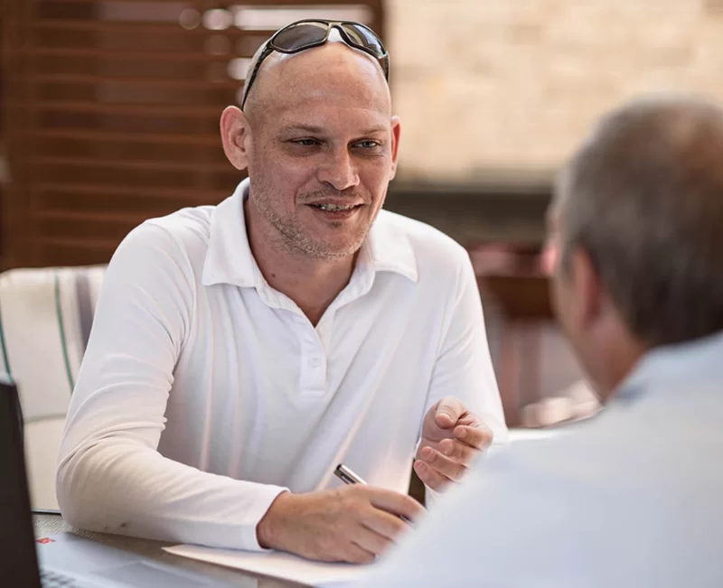 Elderly Man Consulting a Community Justice Staff