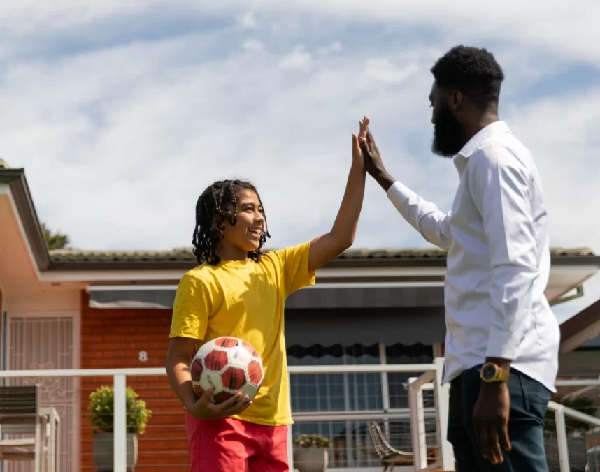 Foster Care Staff and Child Doing a High-Five