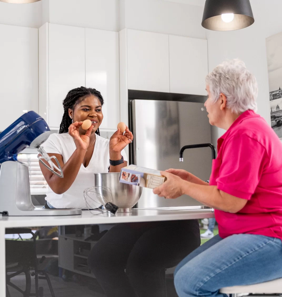 NDIS Staff Preparing Meal for Elderly Woman