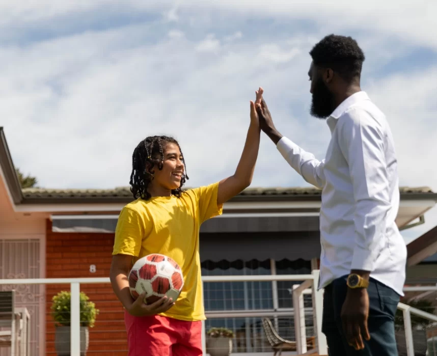 Foster Care Staff and Child Doing a High-Five