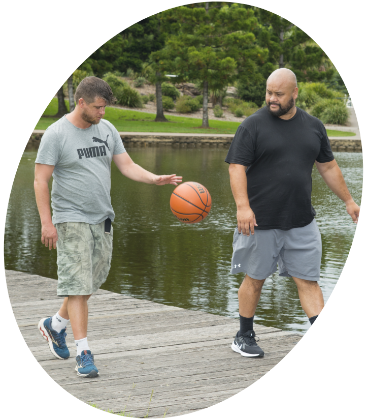 Man Dribbles Ball While Taking a Walk with NDIS Staff