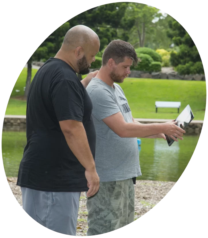 Two Men Watching a Video on an iPad